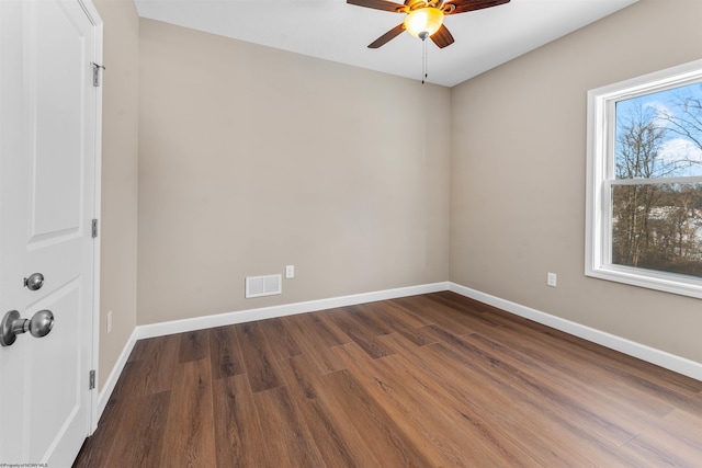 unfurnished room with ceiling fan, plenty of natural light, and dark hardwood / wood-style flooring