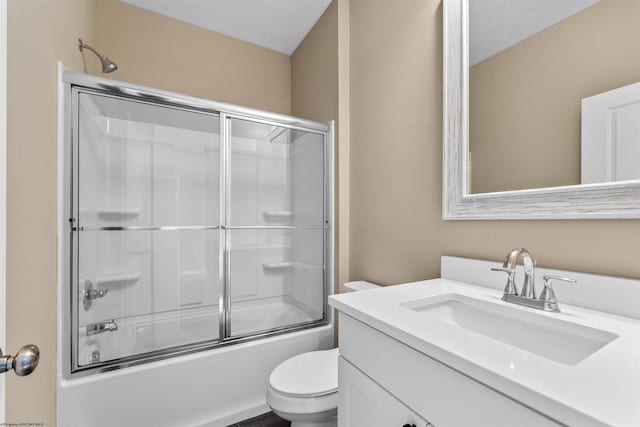 full bathroom featuring vanity, bath / shower combo with glass door, and toilet