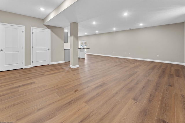 basement with light hardwood / wood-style floors