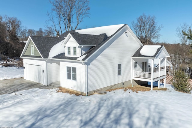 snow covered property featuring covered porch