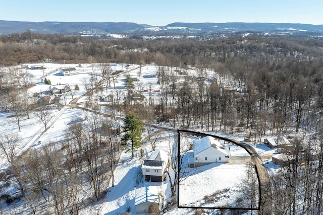 snowy aerial view featuring a mountain view