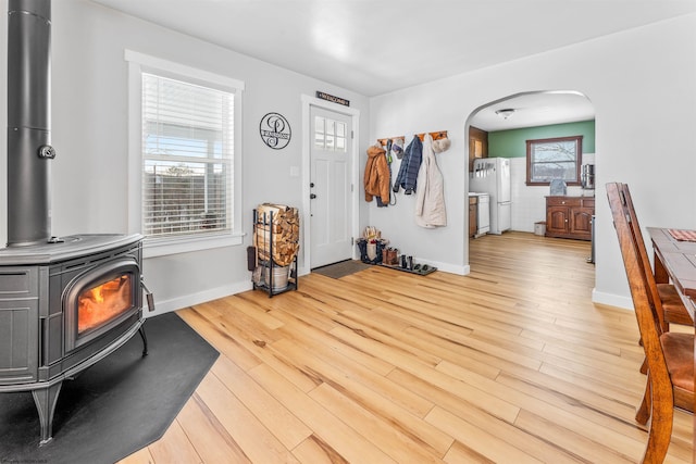 foyer featuring hardwood / wood-style floors and a wood stove