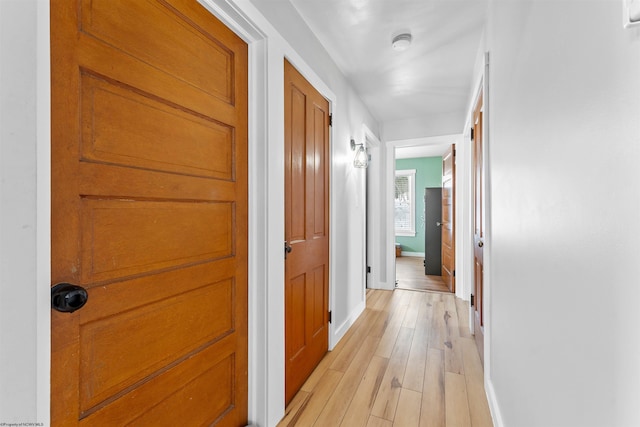 hall with light hardwood / wood-style floors