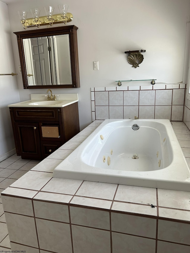 bathroom with tile patterned flooring, vanity, and tiled tub