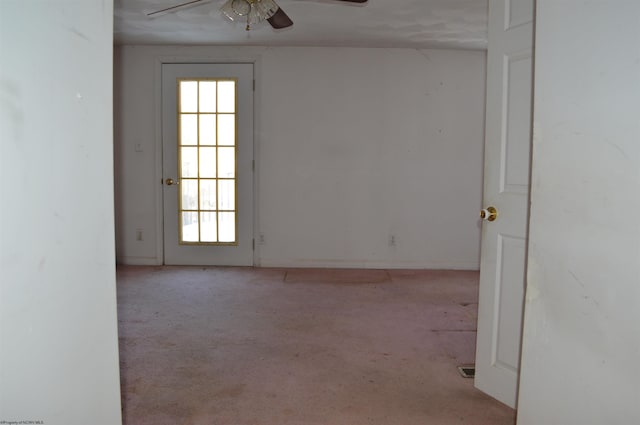 unfurnished room with ceiling fan and light carpet