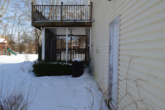 snow covered property with a playground