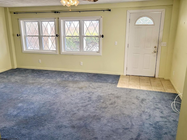 entrance foyer featuring tile patterned flooring and a wealth of natural light