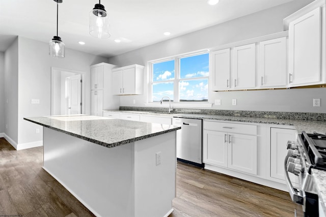 kitchen featuring stainless steel appliances, white cabinetry, and a kitchen island