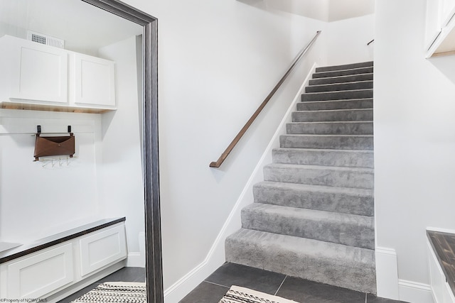 stairway with tile patterned flooring