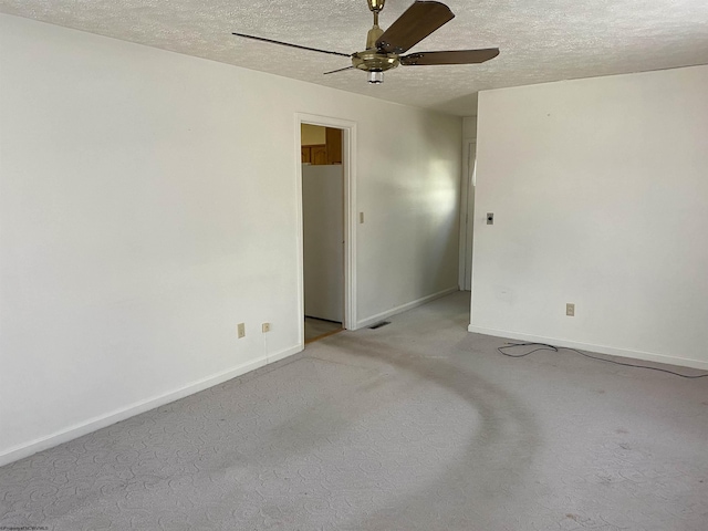 spare room featuring ceiling fan and a textured ceiling