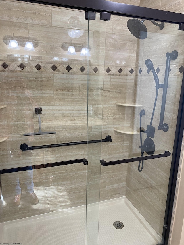 bathroom with a shower with shower door