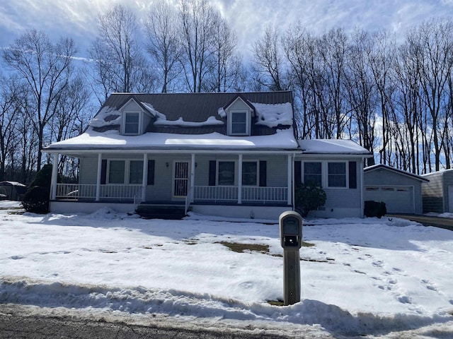 view of front of house with an outbuilding, a garage, and a porch