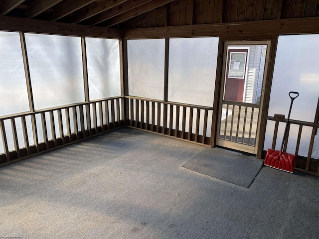 unfurnished sunroom with lofted ceiling