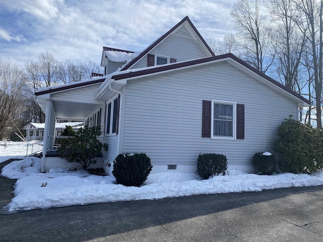 snow covered property featuring a porch