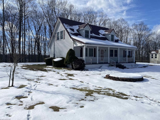 cape cod home featuring a porch