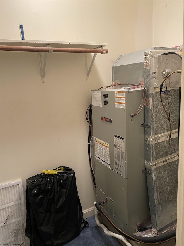 utility room with heating unit