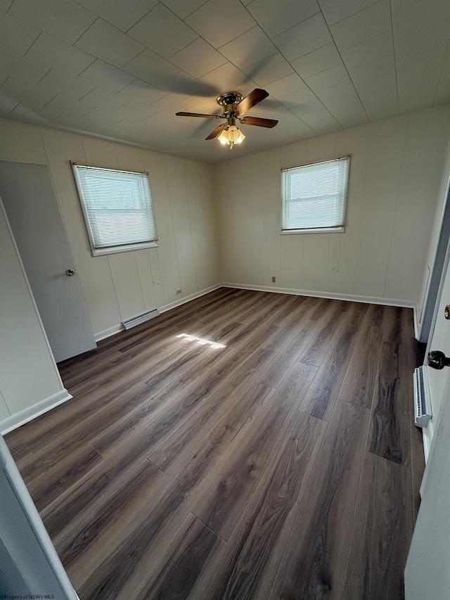 empty room featuring dark hardwood / wood-style floors and ceiling fan