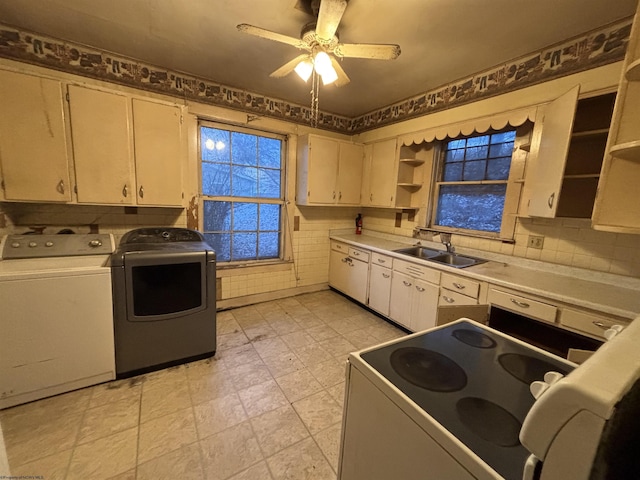 kitchen with ceiling fan, separate washer and dryer, sink, and white range with electric stovetop