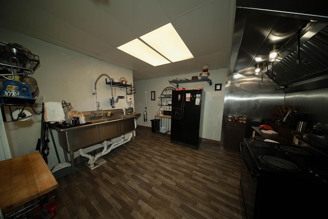 interior space featuring dark hardwood / wood-style flooring and black appliances