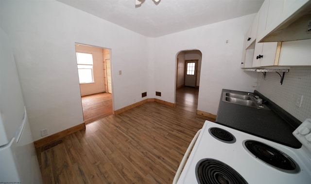 kitchen featuring white cabinetry, white electric range, dark hardwood / wood-style flooring, and sink