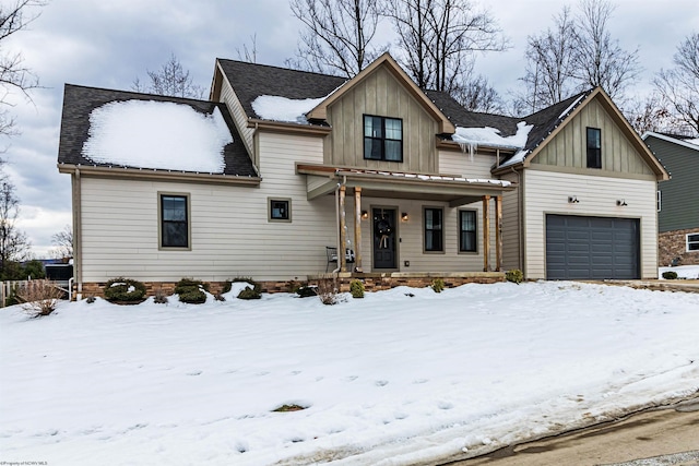 view of front of home with a porch and a garage