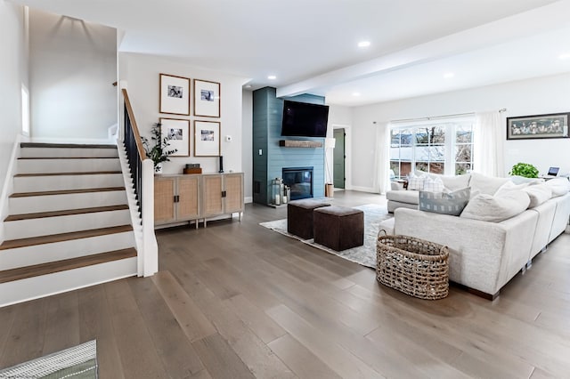 living room with a fireplace, dark hardwood / wood-style floors, and beamed ceiling