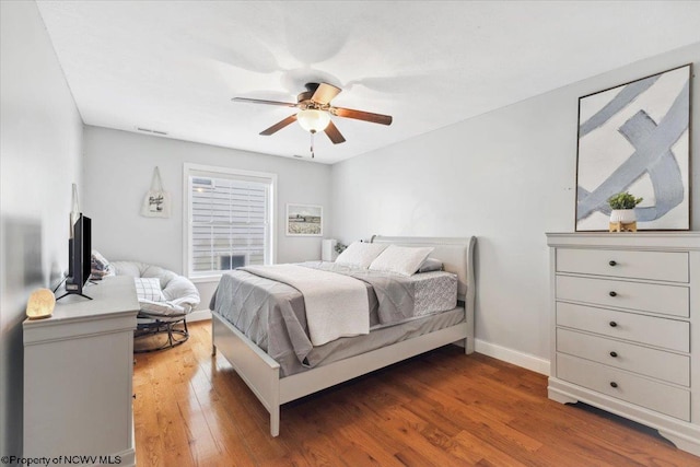 bedroom with dark wood-type flooring and ceiling fan