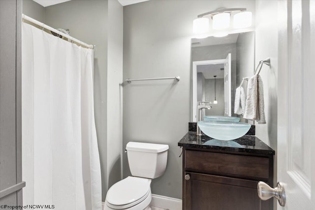 bathroom featuring vanity and toilet