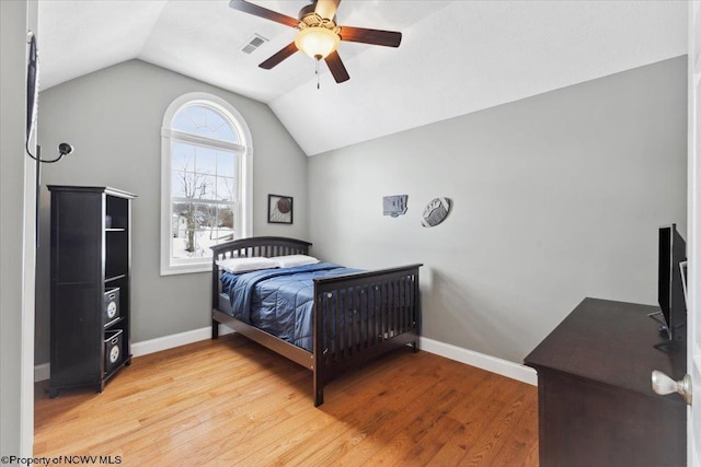 bedroom featuring ceiling fan, lofted ceiling, and hardwood / wood-style floors