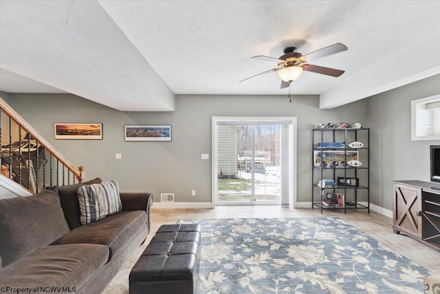 living room with light tile patterned flooring, a healthy amount of sunlight, and a textured ceiling