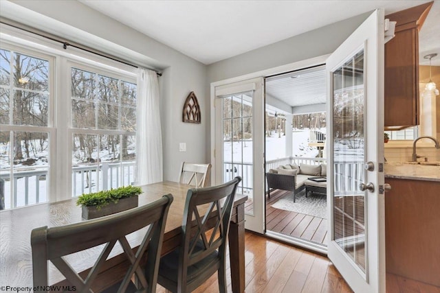 dining area featuring sink, hardwood / wood-style floors, and french doors