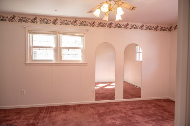 carpeted spare room featuring ceiling fan