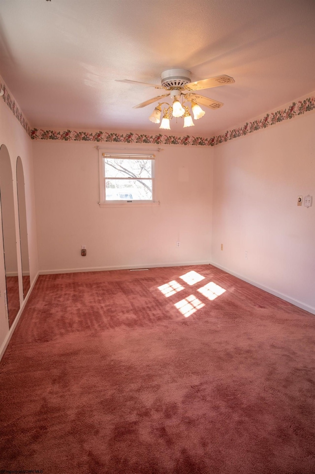 carpeted empty room featuring ceiling fan