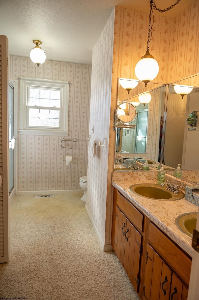 bathroom with vanity, a textured ceiling, and toilet