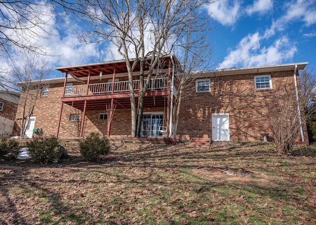 rear view of property featuring a wooden deck