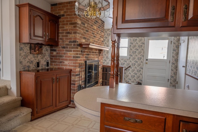 kitchen featuring a fireplace and a notable chandelier