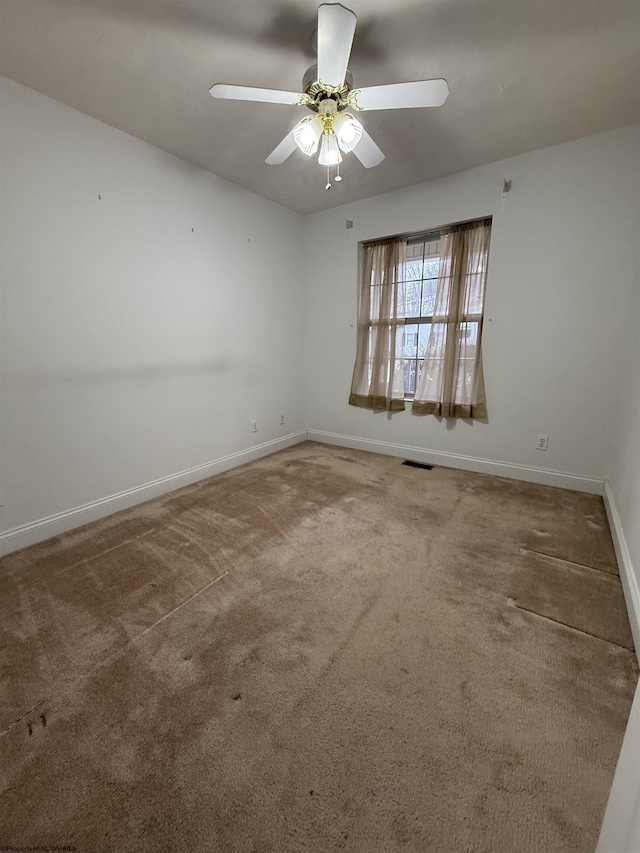 empty room featuring ceiling fan and carpet floors