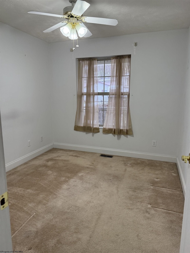 spare room with ceiling fan, carpet floors, and a textured ceiling