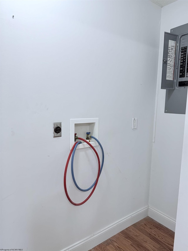 laundry room with wood-type flooring, hookup for an electric dryer, electric panel, and hookup for a washing machine