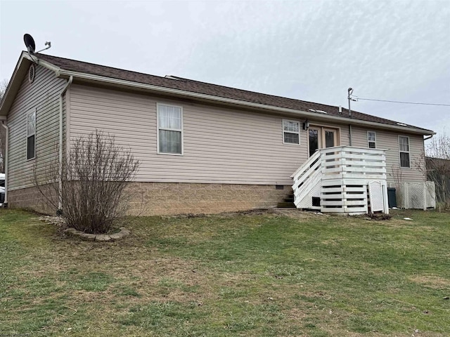 rear view of property featuring a yard