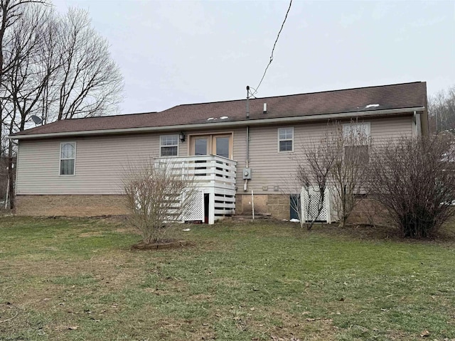 rear view of property with a yard