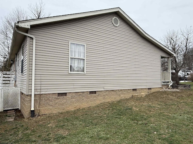 view of side of home with a yard