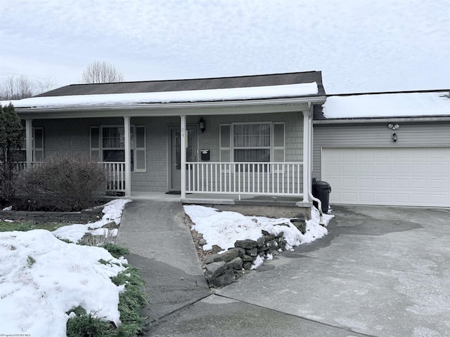 ranch-style home with a garage and covered porch