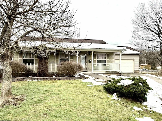 view of front of home featuring a garage, a front lawn, and covered porch