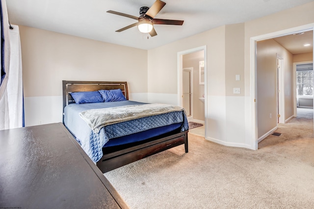 carpeted bedroom with connected bathroom and ceiling fan