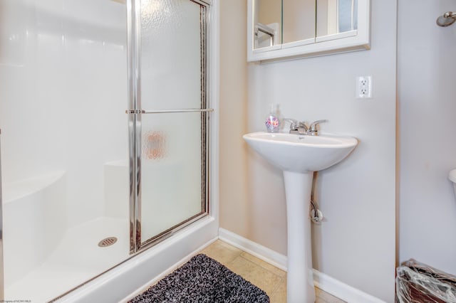 bathroom with tile patterned flooring and walk in shower