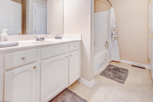 bathroom with shower / bath combo, tile patterned floors, and vanity