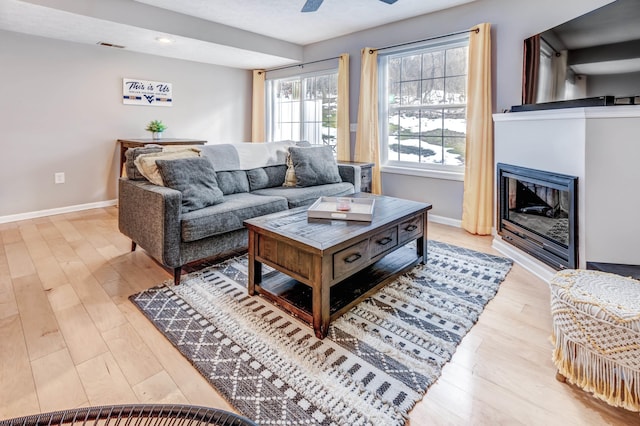 living room featuring light hardwood / wood-style floors and ceiling fan