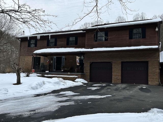 view of front of home with a porch and a garage