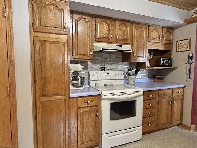 kitchen featuring tasteful backsplash and electric range